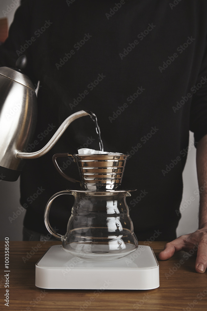 Barista spills boiled water in drip coffee maker Barista spills boiled water in drip coffee maker