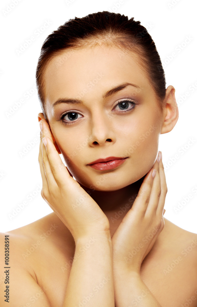 Beautiful young woman touching her face Beautiful young woman touching her face