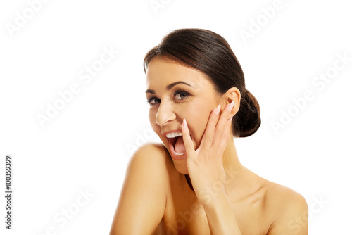 Beautiful laughing spa woman, touching her face