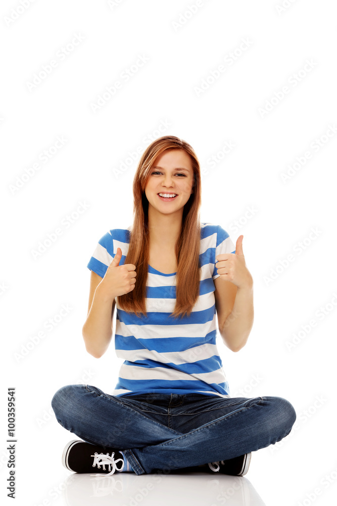 Happy teenage woman sitting with cross legged Happy teenage woman sitting with cross legged