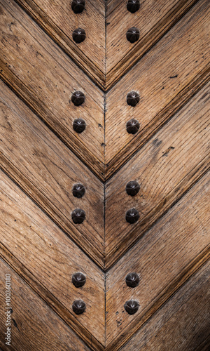 Old wooden door texture with metal nails