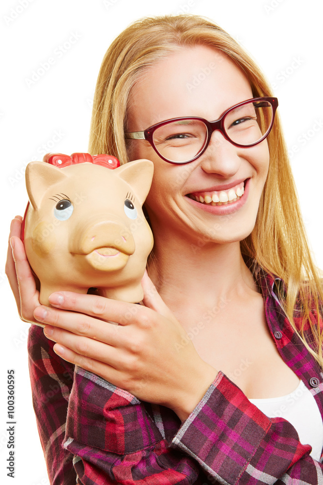 Smiling young woman holding piggy bank Stock Photo | Adobe Stock