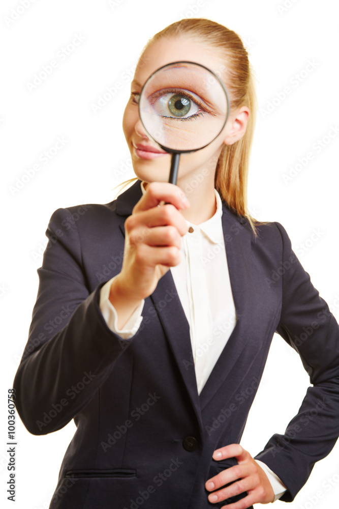 Eye of businesswoman through magnifying glass Eye of businesswoman through magnifying glass
