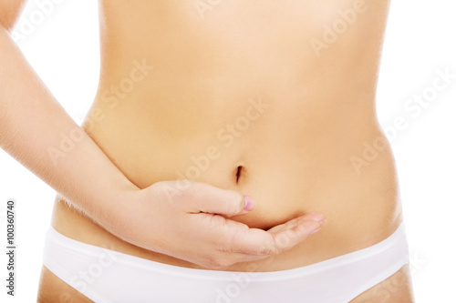 Young woman belly with hand on it