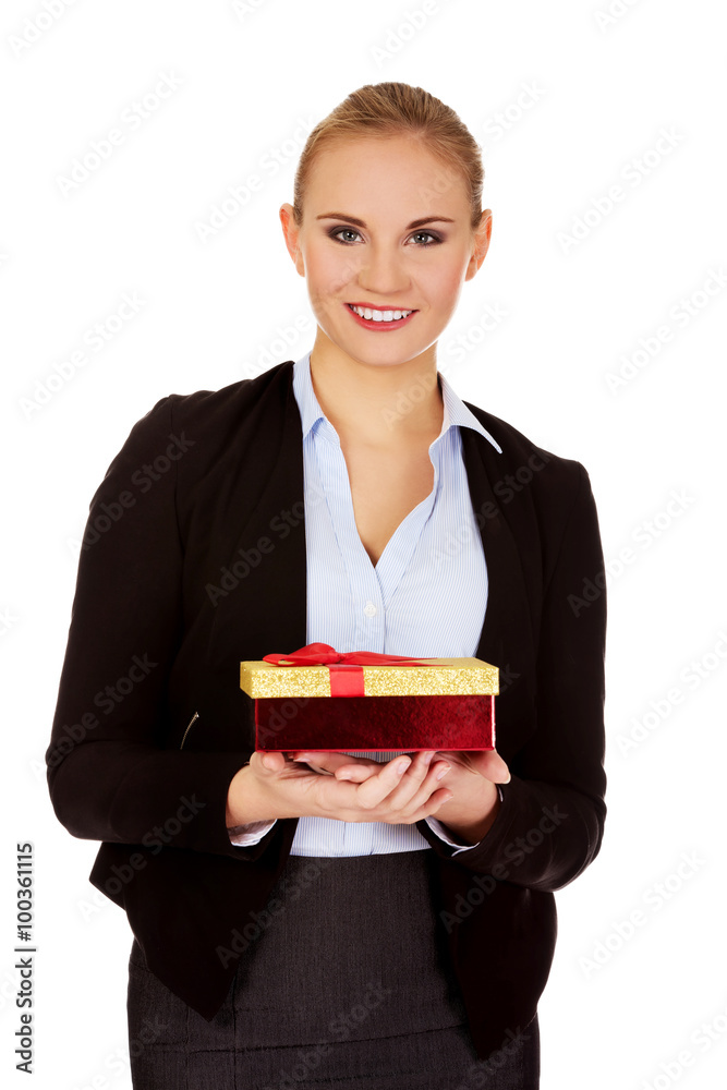 Smiling young business womamn holding present box Smiling young business womamn holding present box