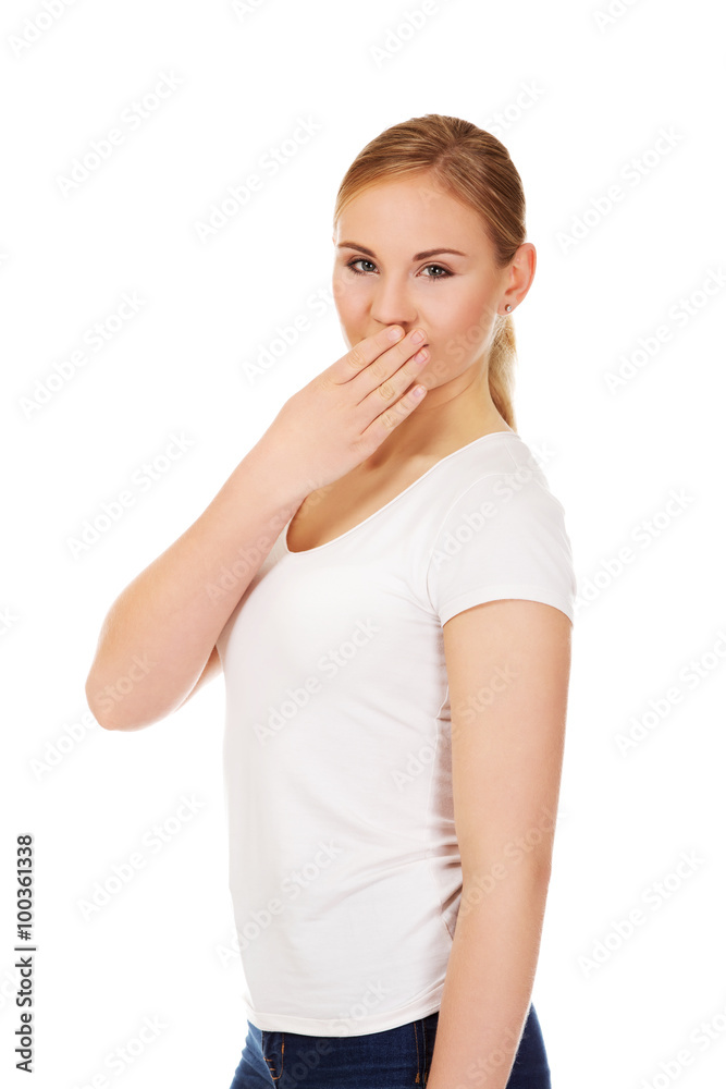 Giggles young woman covering her mouth with hand Giggles young woman covering her mouth with hand