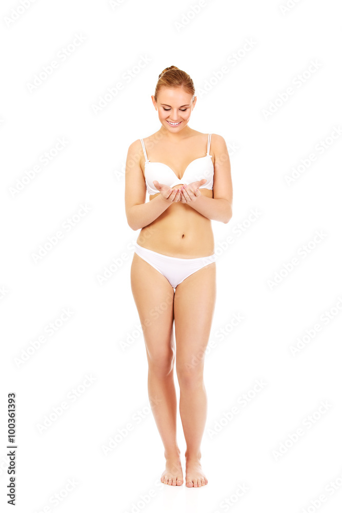 Young woman in lingerie holding something on open palms Young woman in lingerie holding something on open palms