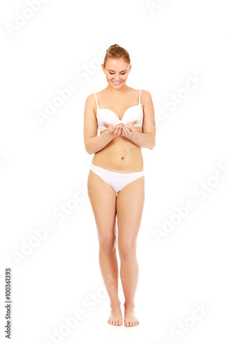 Young woman in  lingerie holding something on open palms 