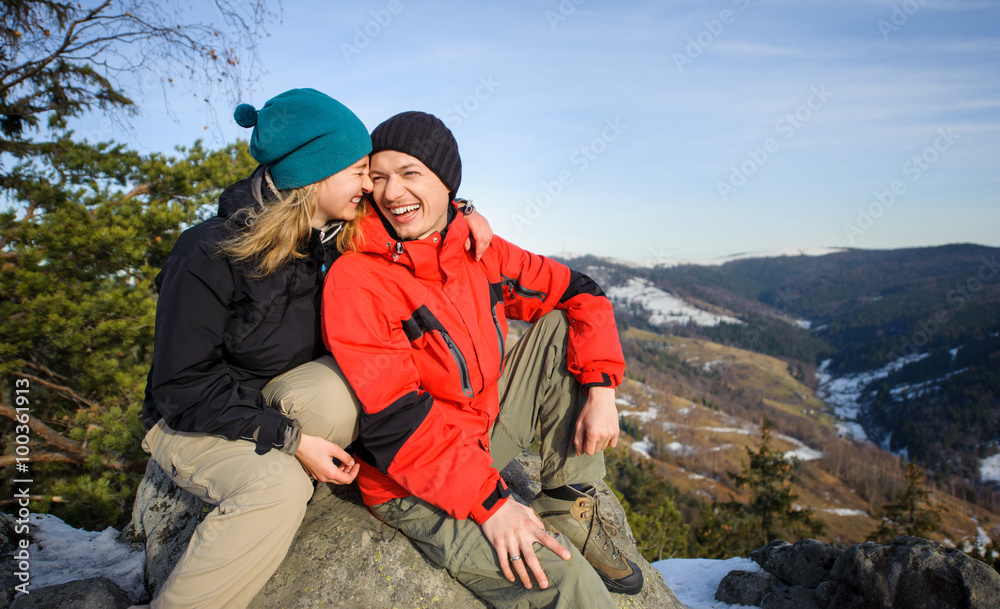 Portrait of happy hikers relaxing on top of the mountain