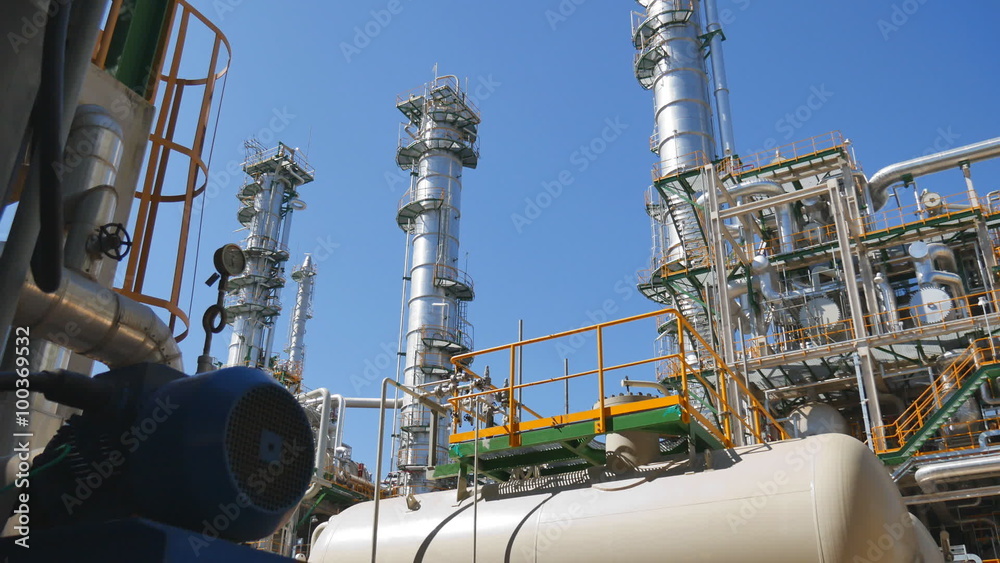 Refinery tower and steel pipe line in process area of Industrial refinery plant with blue sky Refinery tower and steel pipe line in process area of Industrial refinery plant with blue sky