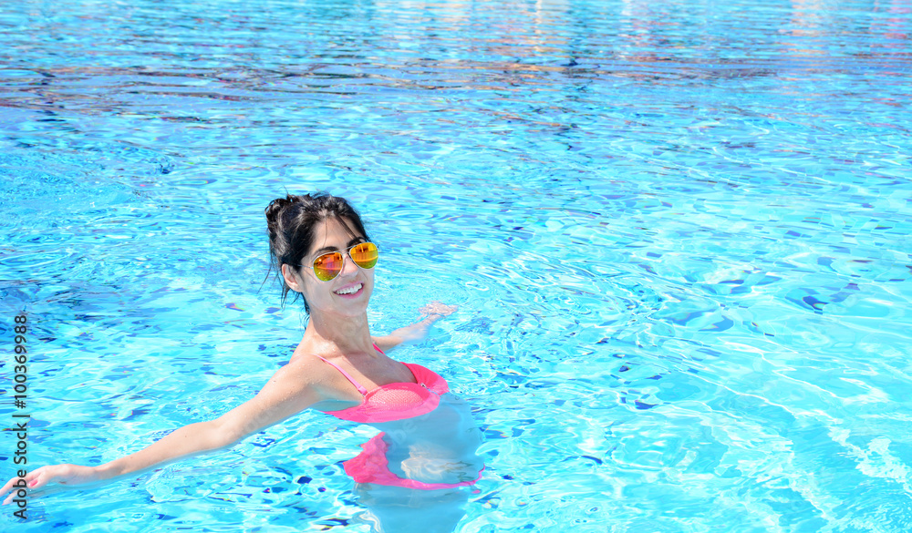 young beautiful  woman swimming in a pool .Summer holiday