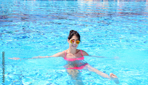 young beautiful woman swimming in a pool .Summer holiday