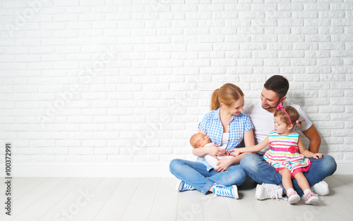 happy family father mother and children at empty wall photo