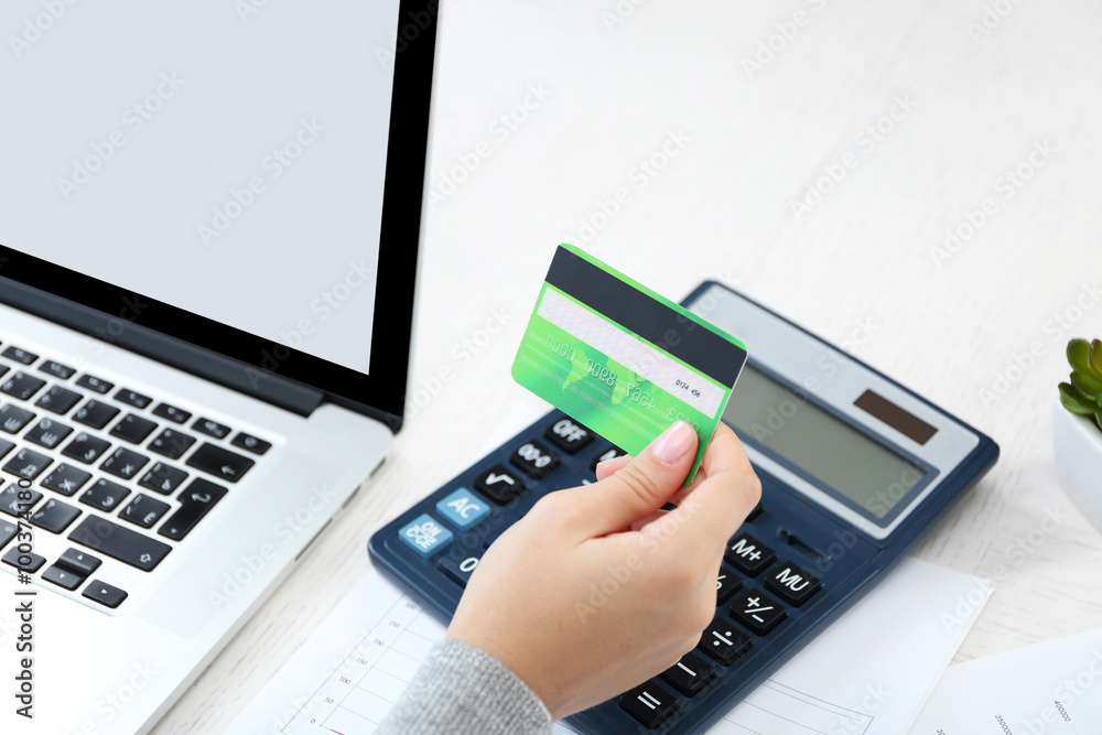 Concept for Internet shopping: hands with laptop and credit card Concept for Internet shopping: hands with laptop and credit card