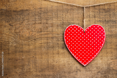 Red heart hanging on clothesline for Valentine Day