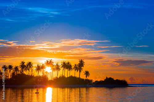 Beautiful colorful sunset at tropical island on Maldives in Indian Ocean