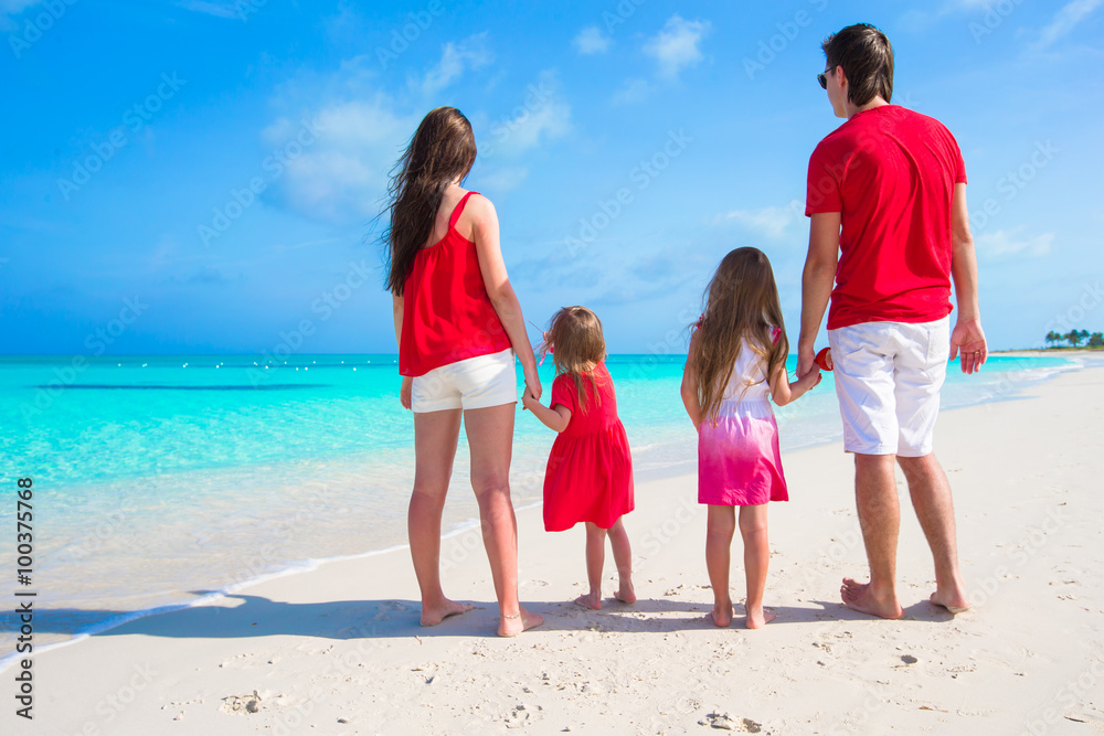 Happy family on white beach during summer vacation