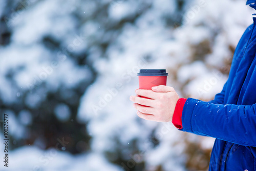 Closeup man drinking coffee in frozen winter day outdoors