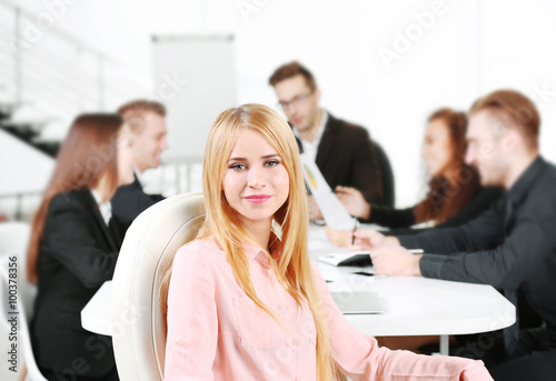 Photo of business woman with her staff in conference room at the meeting