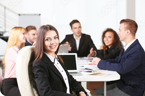 Photo of business woman with her staff in conference room at the meeting
