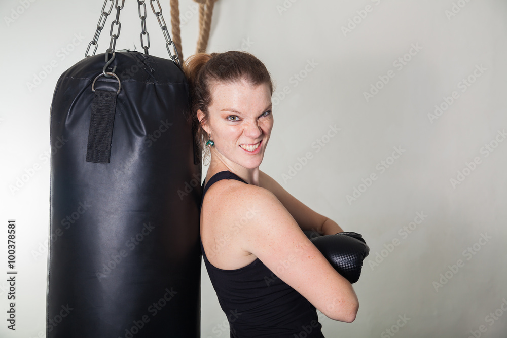 Young blonde woman in a boxing gym for a workout