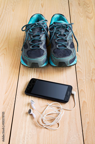 Sport sneakers and smartphone with headphones