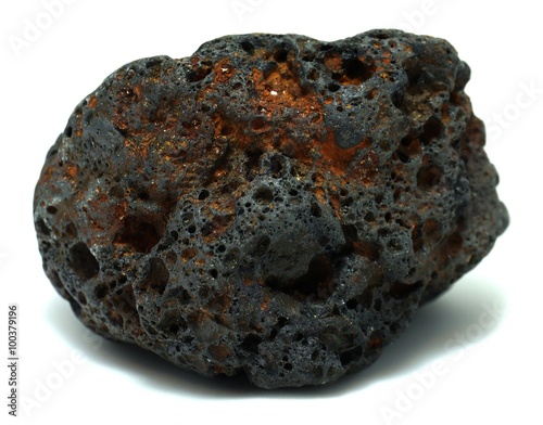 Reddish black volcanic basalt rock on white background photo