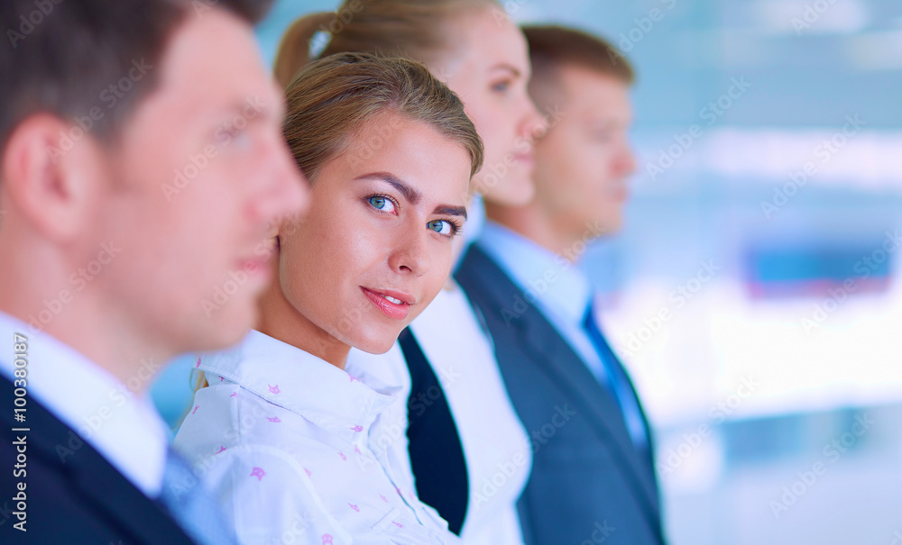 Smiling successful business team standing in office Smiling successful business team standing in office