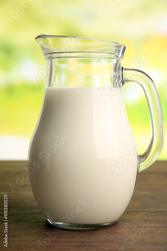 Jar of milk on blurred natural background