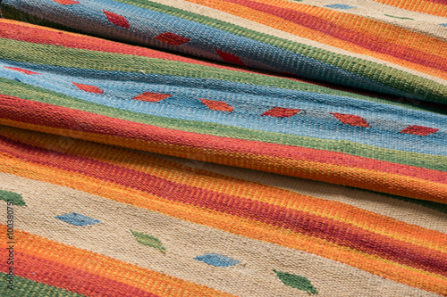 Close up of a hand woven striped patterned indian runner kilim