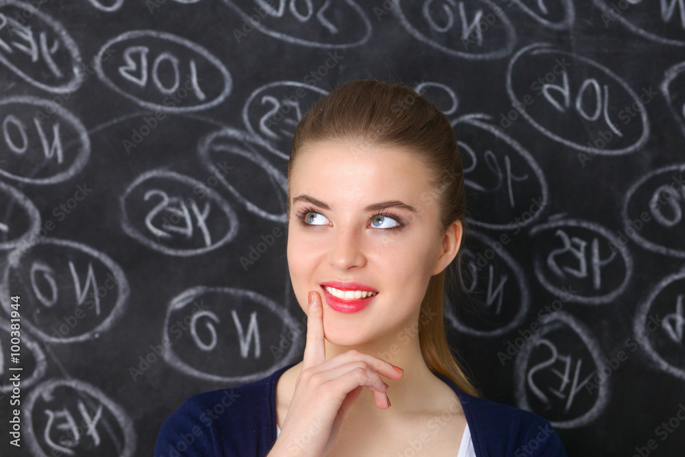 Thinking young woman with yes or no choice on gray background