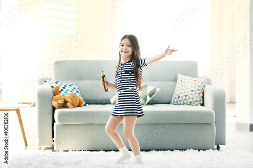 Beautiful little girl singi...