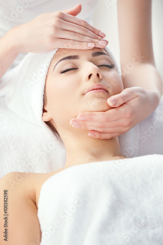 Spa concept. Face massage. Young woman getting spa treatment, close up