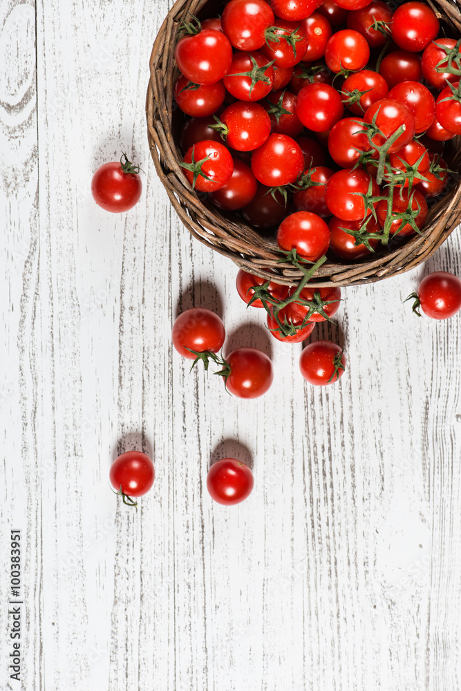 Wicker basket with cherry tomatoes, top view Wicker basket with cherry tomatoes, top view