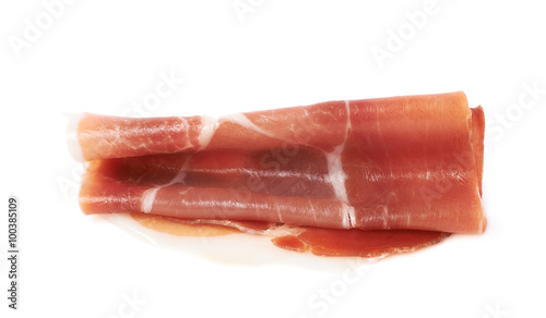 Folded prosciutto ham slice isolated