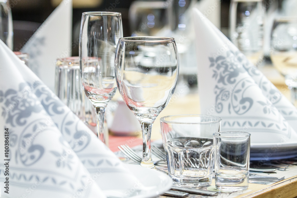 A banquet table with wineglasses and serviettes A banquet table with wineglasses and serviettes