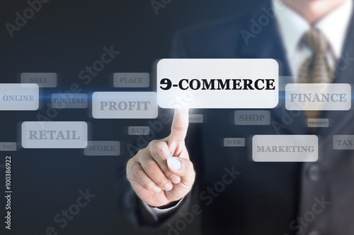 Businessman pressing E-COMMERCE concept button. Can be used in advertising.