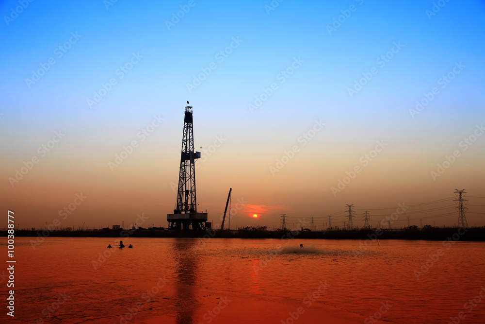 In the evening, the silhouette of oilfield derrick