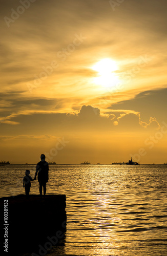Silhouette people under sunset sky