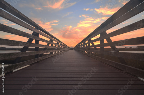 Wooden Boardwalk at sunset at Bolsa Chica Wetlands preserve in Huntington Beach, California, United States photo