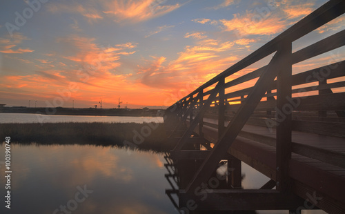 Wooden Boardwalk at sunset at Bolsa Chica Wetlands preserve in Huntington Beach, California, United States photo