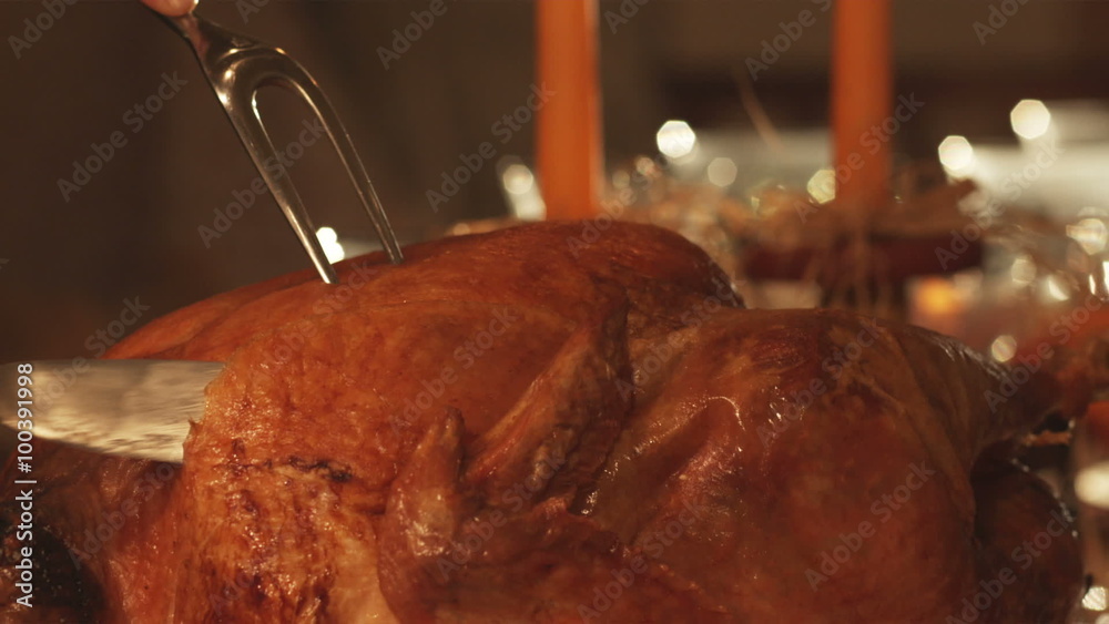 Thanksgiving day turkey being carved, tradional holiday.