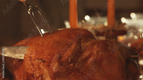 Thanksgiving day turkey being carved, tradional holiday.
