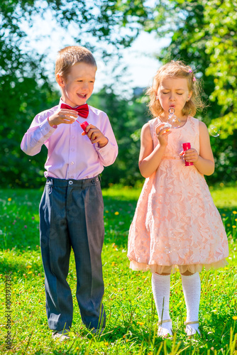 funny kids on a holiday makes soap bubbles