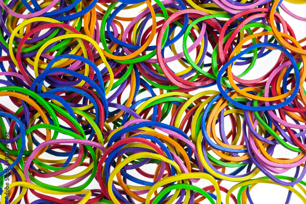 Colorful rubber bands on white background.