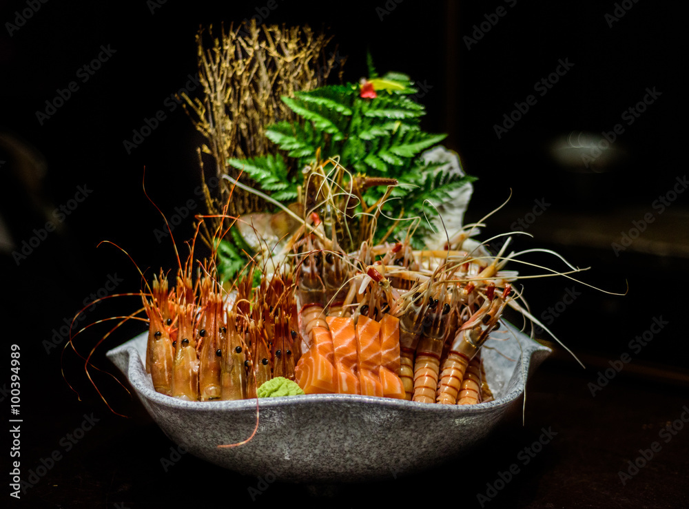 Japanese raw seafood buffet. Food of Japan. Japanese sushi bar and  restaurant food. Raw salmon and raw prawns on ice. Stock Photo | Adobe Stock