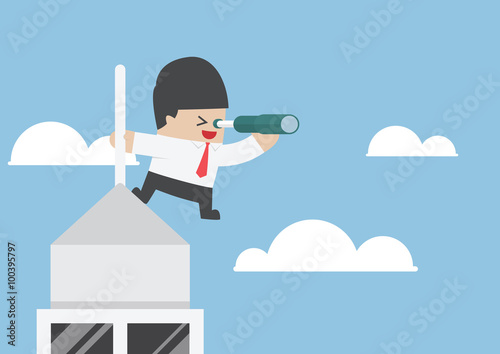 Businessman looking through spyglass on the top of building
