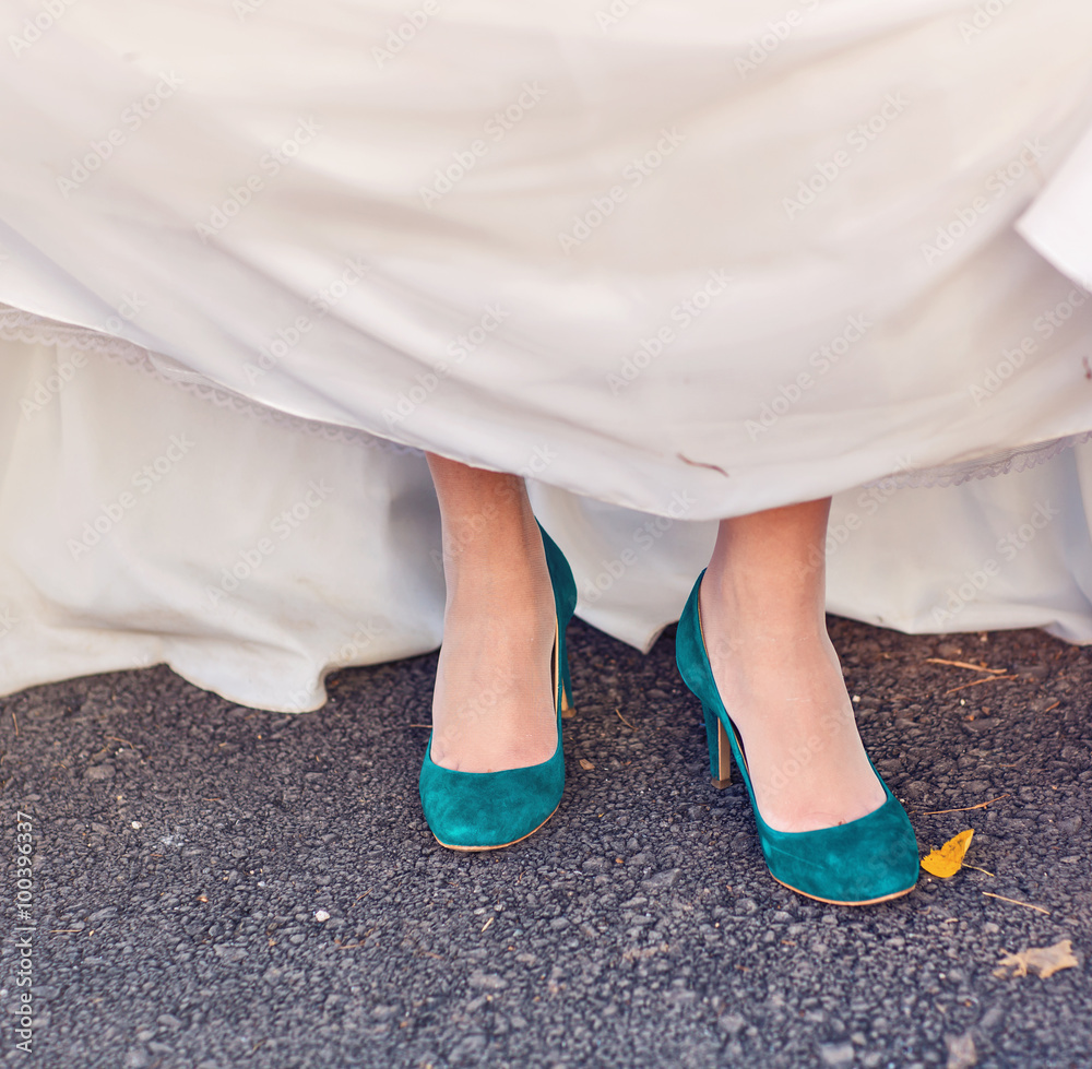 Bride  show off her turquoise shoes at wedding