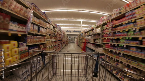 Grocery shopping gart passing through aisle, wide angle.