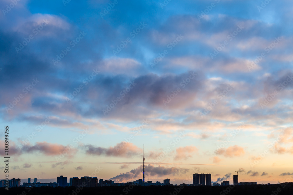 dark blue sky over city in cold winter sunrise